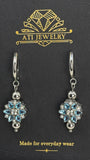 The Love Bloom Earrings in Polished Stainless Steel with Sky Blue Zirconia
