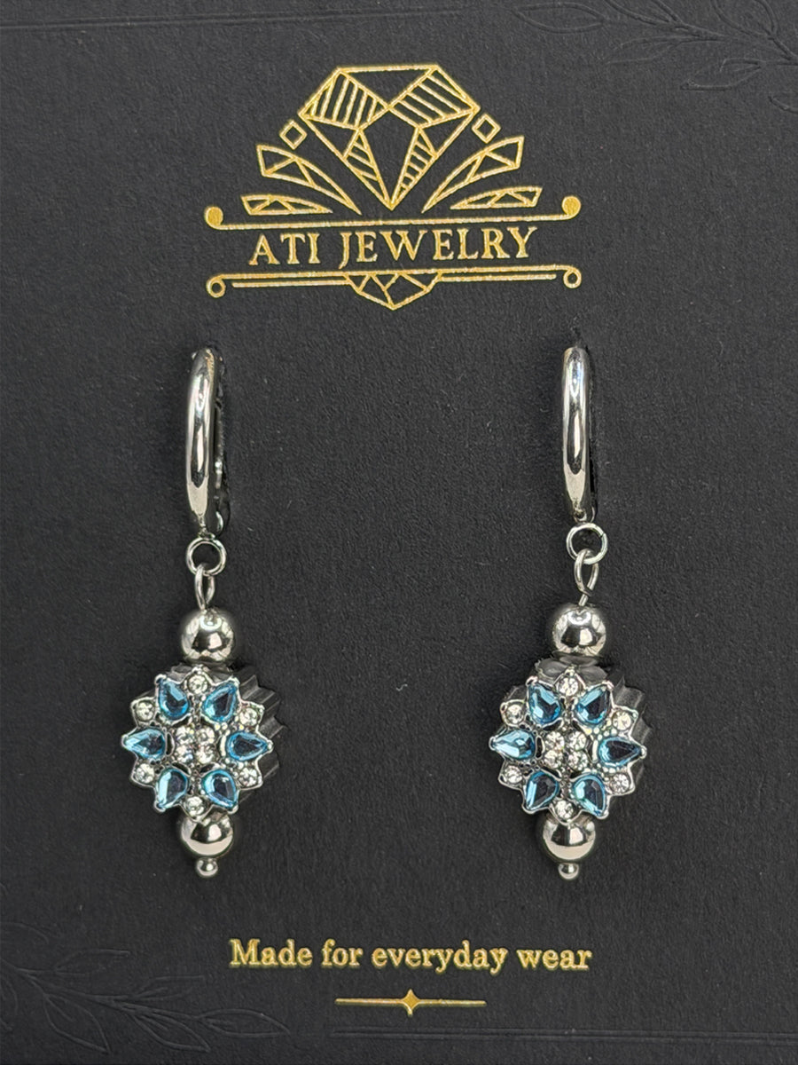 The Love Bloom Earrings in Polished Stainless Steel with Sky Blue Zirconia