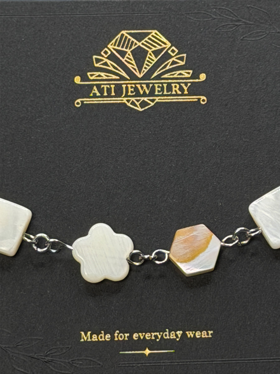 The Nacre Mosaic Bracelet in polished stainless steel with natural mother-of-pearl details
