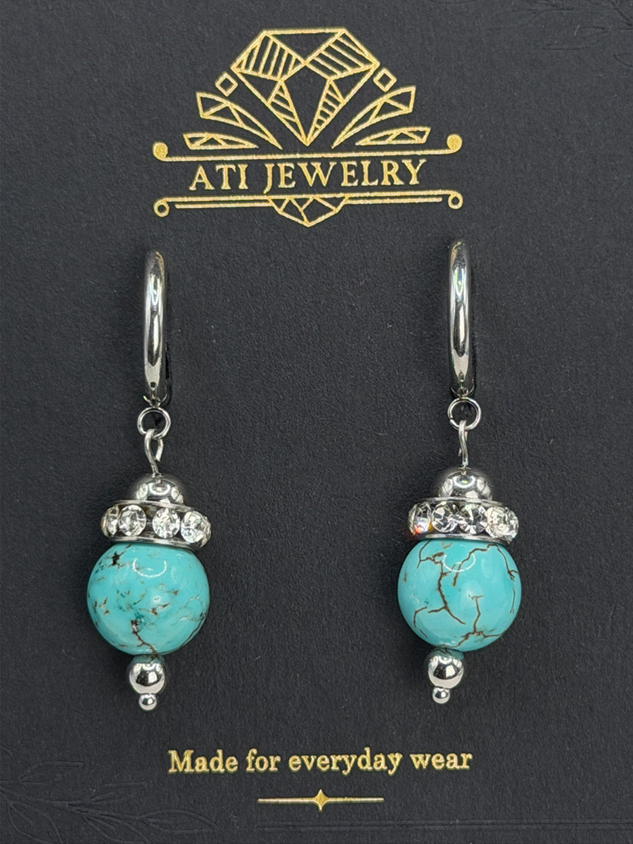 The Duchess Drop Earrings in Polished Stainless Steel with turquoise-toned beads and crystal accents