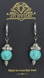 The Duchess Drop Earrings in Polished Stainless Steel with turquoise-toned beads and crystal accents