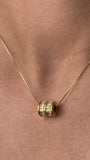 Close-up of the crystal-set barrel pendant and delicate snake chain
