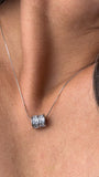 Close-up of the crystal-set barrel pendant and delicate snake chain
