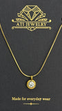The Elara Necklace in 18K gold finish with clear crystal charm on ATI Jewelry card