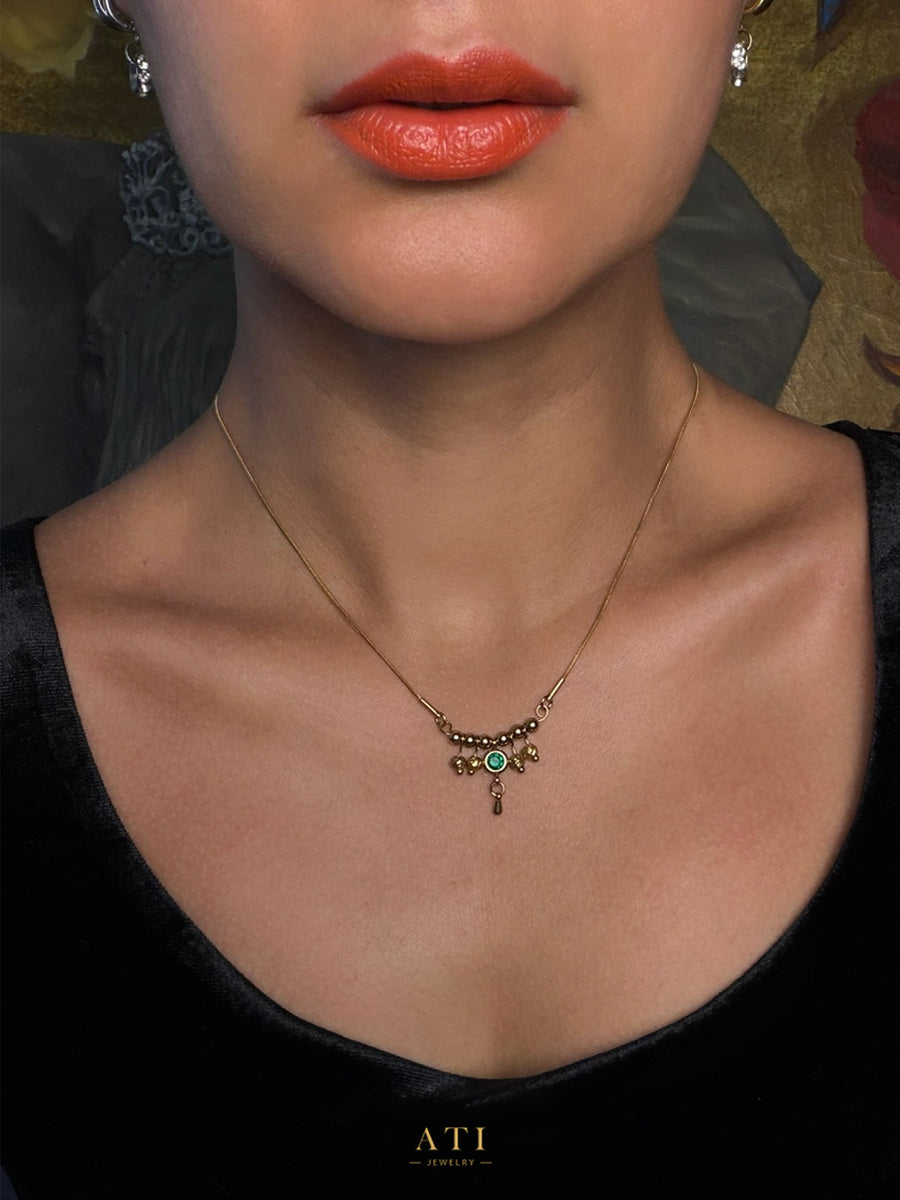 Gold Queen Necklace with Emerald Green crystal centerpiece and suspended metal details