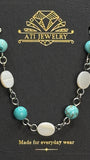 The Shoreline Necklace in Polished Stainless Steel with shell and turquoise beads