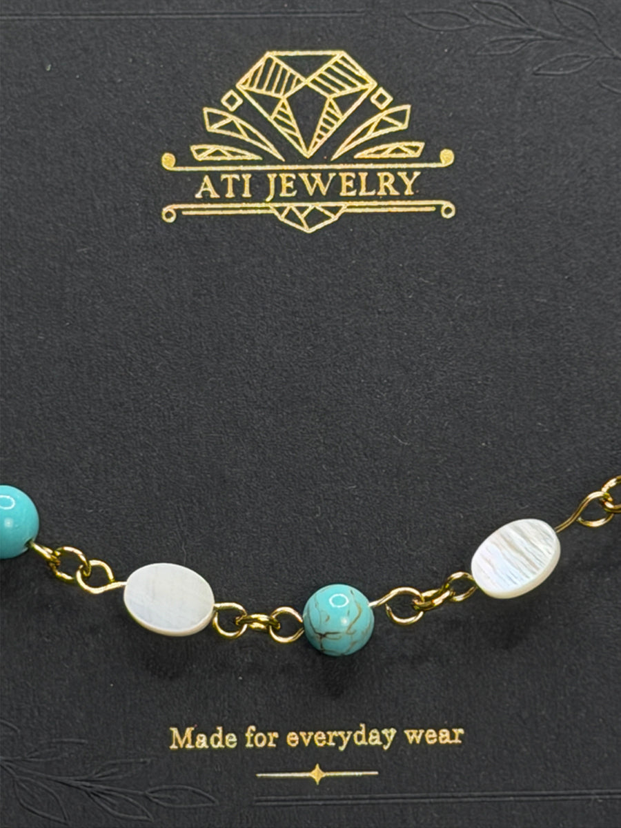 The Shoreline Bracelet with white shell and turquoise beads in 18K Gold Finish