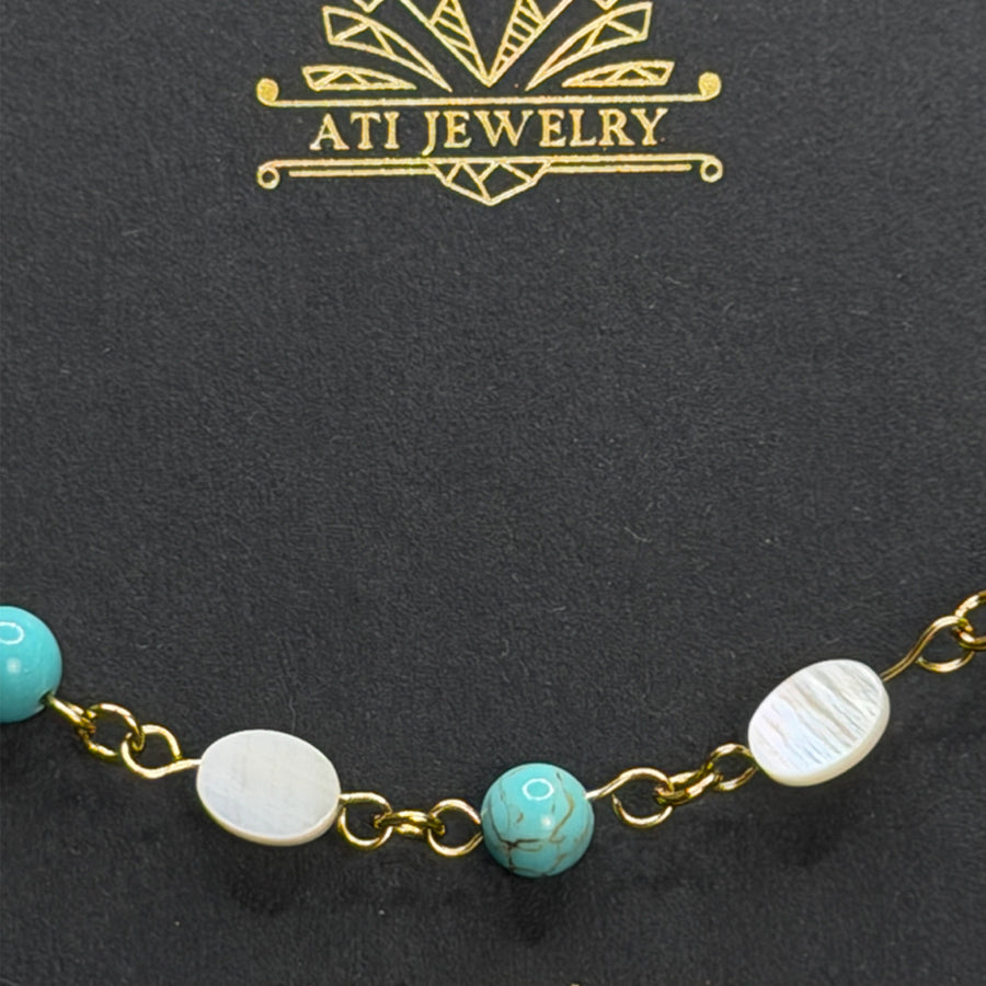 The Shoreline Bracelet with white shell and turquoise beads in 18K Gold Finish
