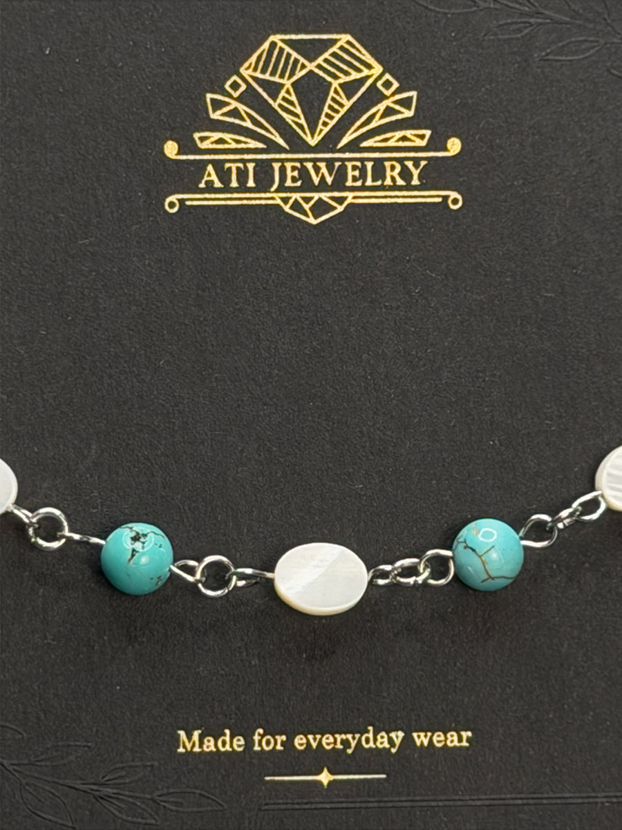The Shoreline Bracelet in Polished Stainless Steel with shell and turquoise beads