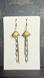 Long antique brass-tone earrings with geometric fan-shaped panels, white pearl-like beads, and layered chain tassels.